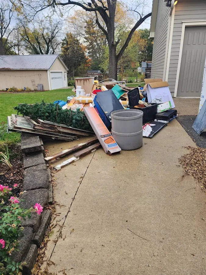 Dumpster being loaded with debris for Roofing Dumpster Rental in Flemingsburg